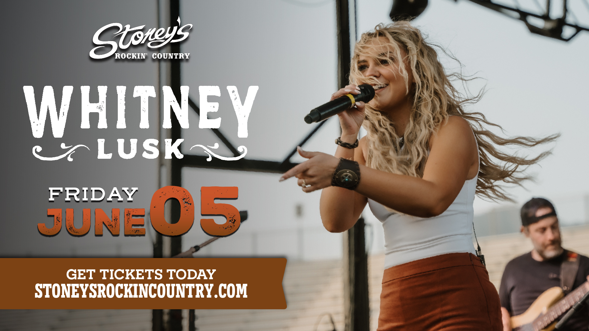 Whitney Lusk performing live country music on stage