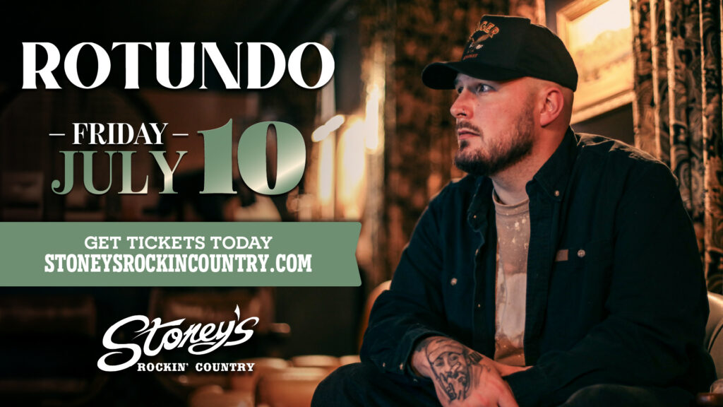 Rotundo performing live on stage during a country music concert